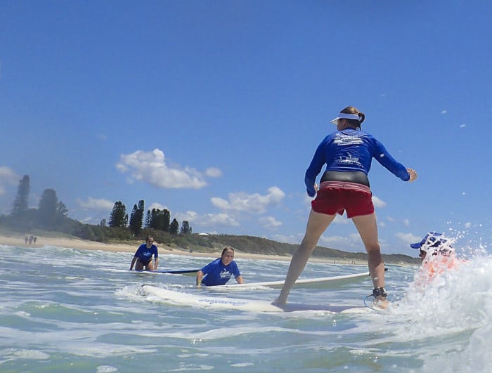 Surfing lesson at Coolum beach - the beaches are a major factor in people moving to Sunshine Coast 