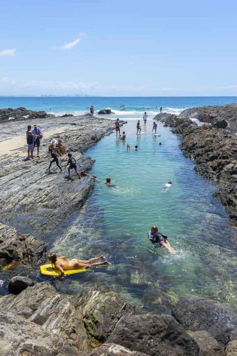 snapper rocks with kids playing in water 